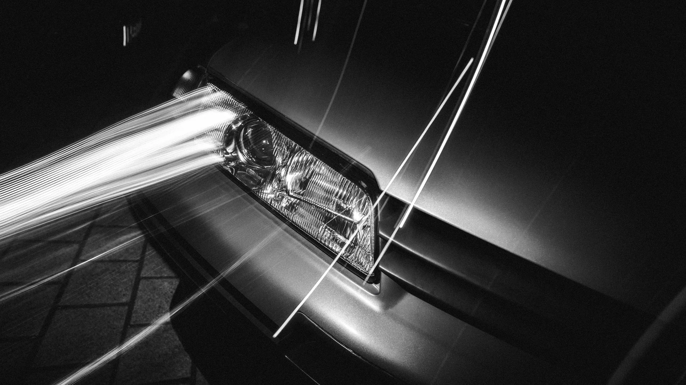 Headlight with long exposure light trails, black and white